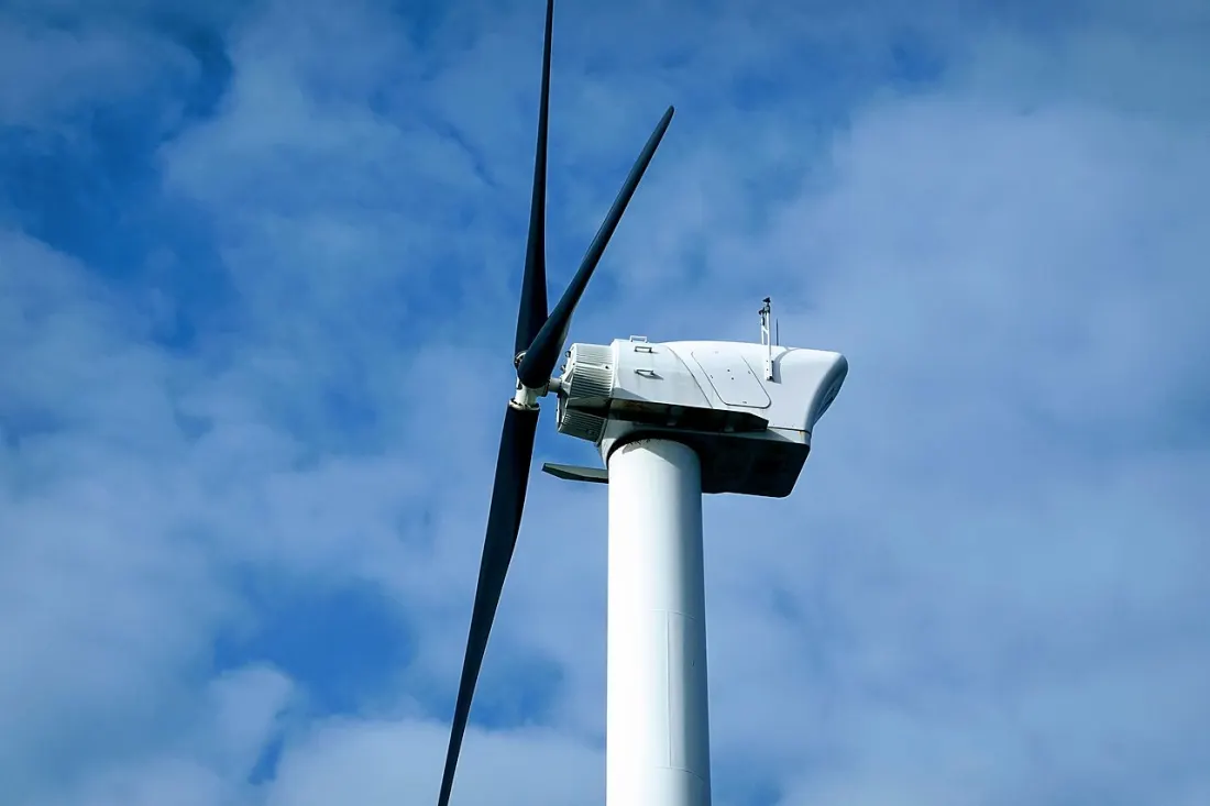 Renewable energy and carbon offset advisory — wind farm at sunset